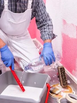 House painter worker at work in the construction site. Building. Stock Photos