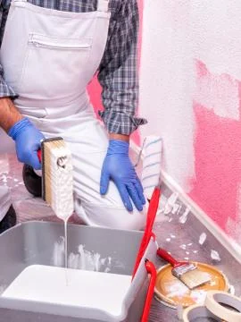 House painter worker at work in the construction site. Building. Stock Photos