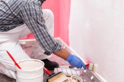 House painter worker at work in the construction site. Building. Stock Photos