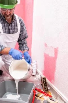House painter worker at work in the construction site. Building. Stock Photos