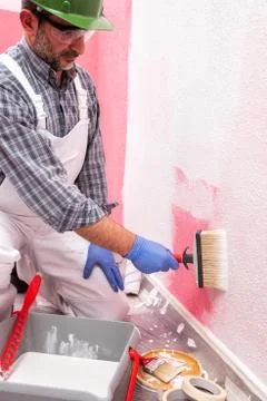 House painter worker at work in the construction site. Building. Stock Photos