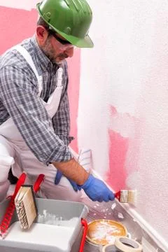 House painter worker at work in the construction site. Building. Stock Photos