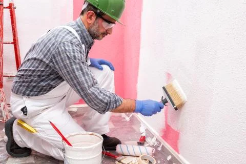 House painter worker at work in the construction site. Building. Stock Photos
