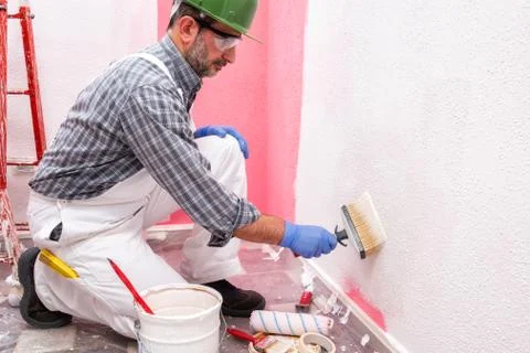 House painter worker at work in the construction site. Building. Foto stock