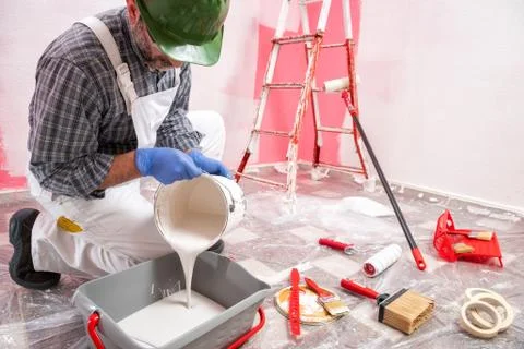 House painter worker at work in the construction site. Building. Stock Photos