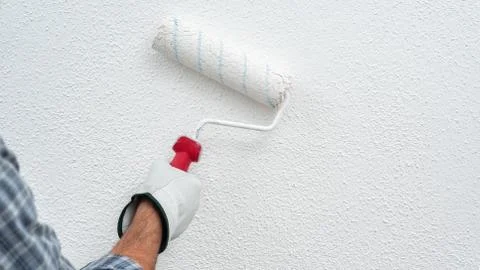 House painter worker at work in the construction site. Building. Stock Photos