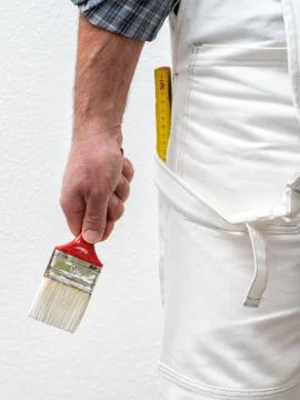 House painter worker at work in the construction site. Building. Stock Photos