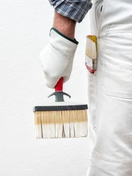 House painter worker at work in the construction site. Building. Stock Photos