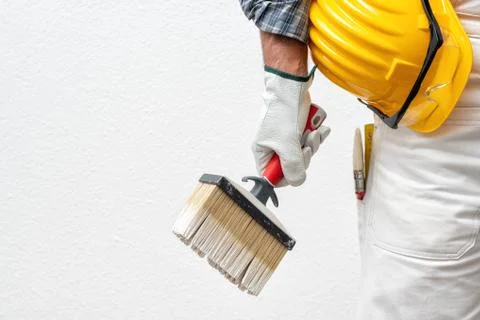 House painter worker at work in the construction site. Building. Stock Photos
