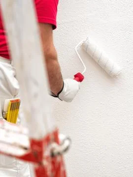 House painter worker at work in the construction site. Building. Stock Photos