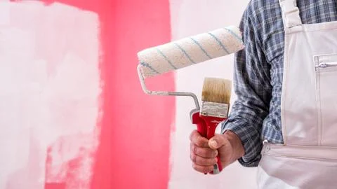 House painter worker with work tools. Construction site. Stock Photos