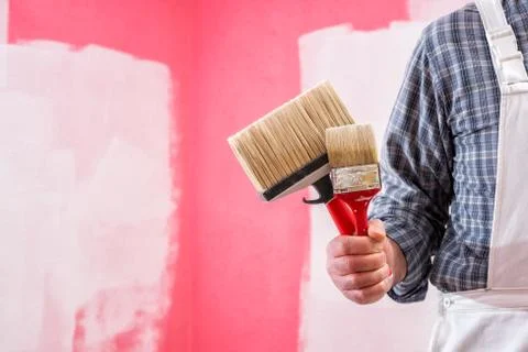 House painter worker with work tools. Construction site. Stock Photos