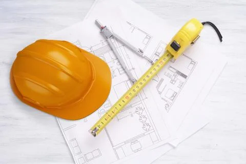 House plan with pencil, flexometer and helmet. Stock Photos