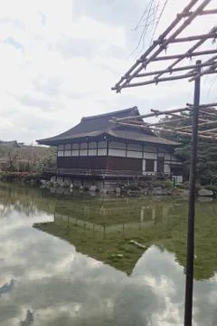 A house in a pond with reflection Stock Photos