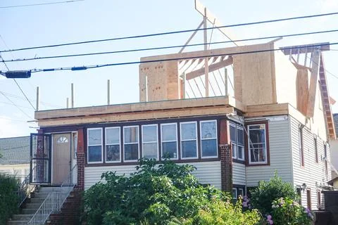 House that is in the process of having a second floor built onto it. Stock Photos
