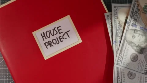 House Project red folder with US dollar cash flat lay Stock Footage 341269374