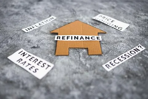 House with refinance text surrounded by concepts like interest rates inflatio Stock Photos