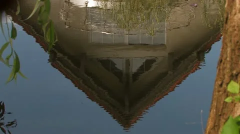 House reflecting in the soft microwaves of a small river Stock Footage 11528207