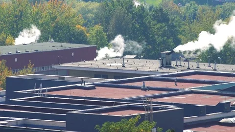 House rooftops, smoke raises from several chimneys  - top view Stock-Footage 82463575