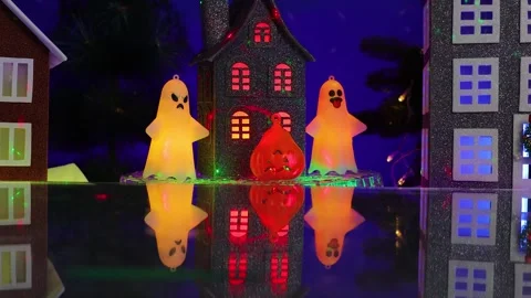 A house rotates surrounded by a pumpkin figure and glowing ghost figures Stock Footage 346601703