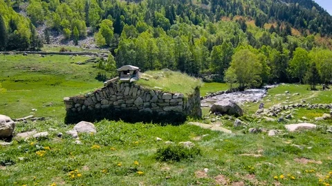 House ruins in the middle of valley Stock Footage