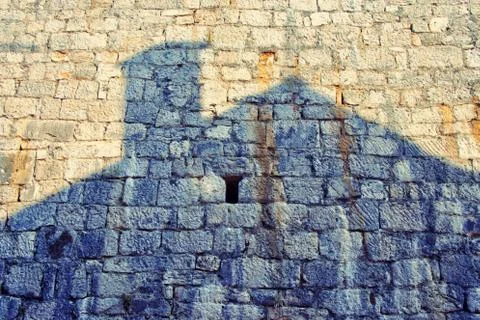 House shadow on an old stone wall Stock Photos