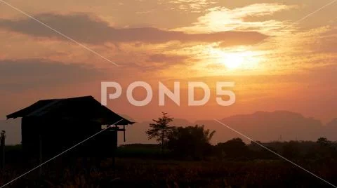 House silhouette with trees at sunset Stock Photos