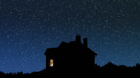 House silhouette under the starry sky at night Stock Footage