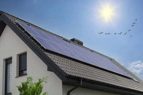 House with solar panels sun heating system on roof. Renewable energy for home Stock Photos