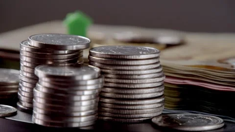 House on stack of Canadian dollars rotating in circle, Canadian Banknotes Money Stock Footage 266340511