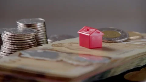 House on stack of Canadian dollars rotating in circle, Canadian Banknotes Money Stock Footage 266340674