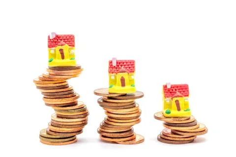 House on stack on white background. Concept uncertainty in the real estate ho Stock Photos