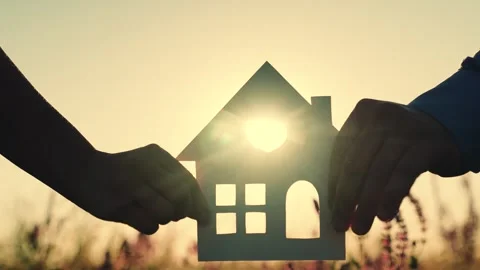 House at sunset. hand close-up. epotheca house purchase. dream to buy jelly Stock Footage 246959173