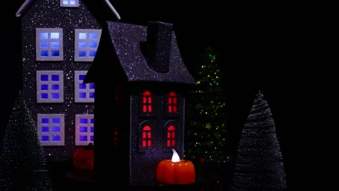A house surrounded by glowing pumpkins and a candle, rotates against of a house Stock Footage 318916834