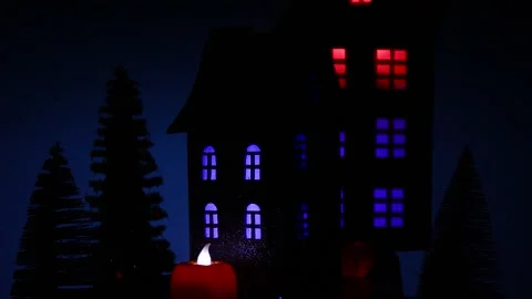 A house surrounded by glowing pumpkins and a candle rotates against of a house Stock Footage 318916930