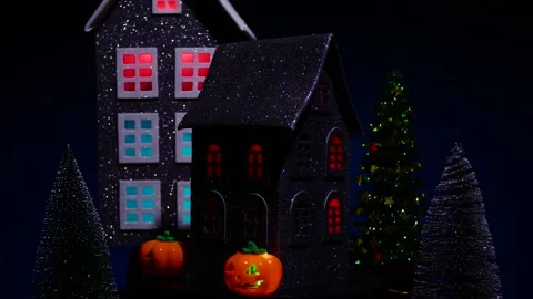 House surrounded by glowing pumpkins and candles rotates against of a house Stock Footage 319293745