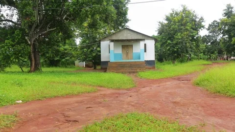 House surrounded by greenery and various trails of dirt path Stock Footage 77443985