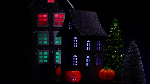 A house surrounded by pumpkins and a candle rotates against of a house Stock Footage 318916758