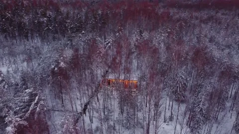 House surrounded by winter forest at sunset on christmas eve. Winter in Russia. Stock Footage 239325506