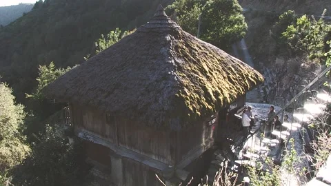 HOUSE WITH THATCH AND PEOPLE TALKING FROM PEDRAFITA DO CEBREIRO Stock Footage 96384250