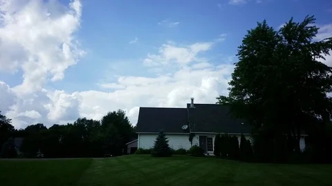 House with timelapse clouds on a nice summer day Stock Footage 94432386