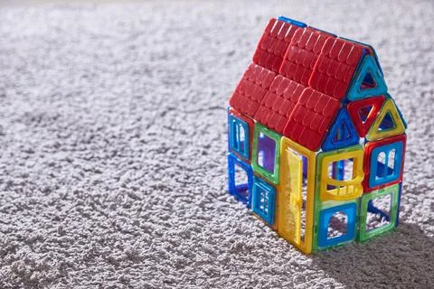 House toy constructor on the carpet. Copy space Stock Photos