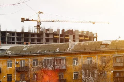 House under construction and construction crane. Old house and new house. H.. Stock Photos