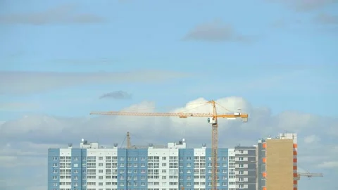 House under construction with cranes over which clouds float. Time-lapse Stock Footage 131659581