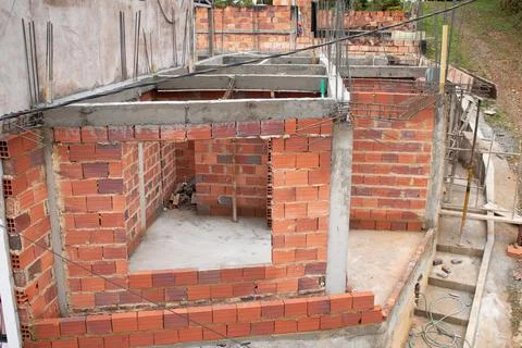 House under construction with its columns and walls recently built. Stock Photos
