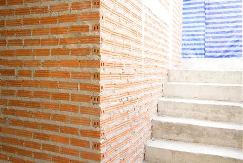 House under construction with red brick wall and stair Stock Photos