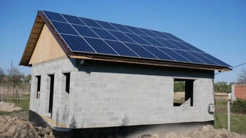 House under construction with solar panels on the roof. Alternative energy. 스톡 사진