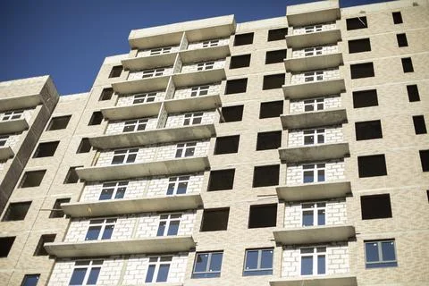 A house under construction. Windows in the building. Stock Photos