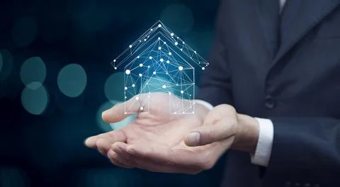 House on virtual screen in man hand Stock Photos