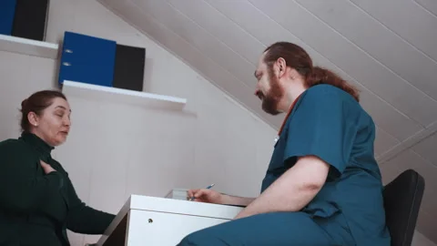 House visit with paramedic. Paramedic examines patient at residence calmly Video stock 342337251